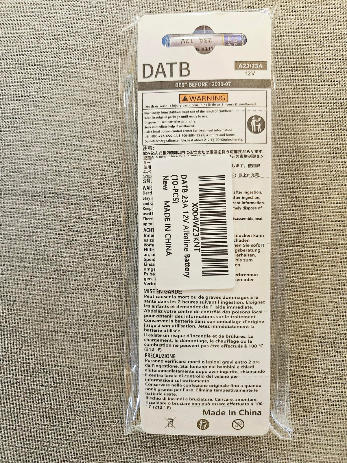 Back of the DATB A23 battery card showing safety warnings and product label