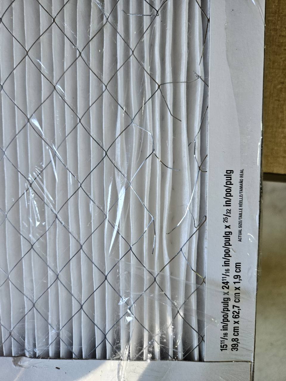 Close-up of minor damage to one unused filter, including bent support mesh and creased pleats