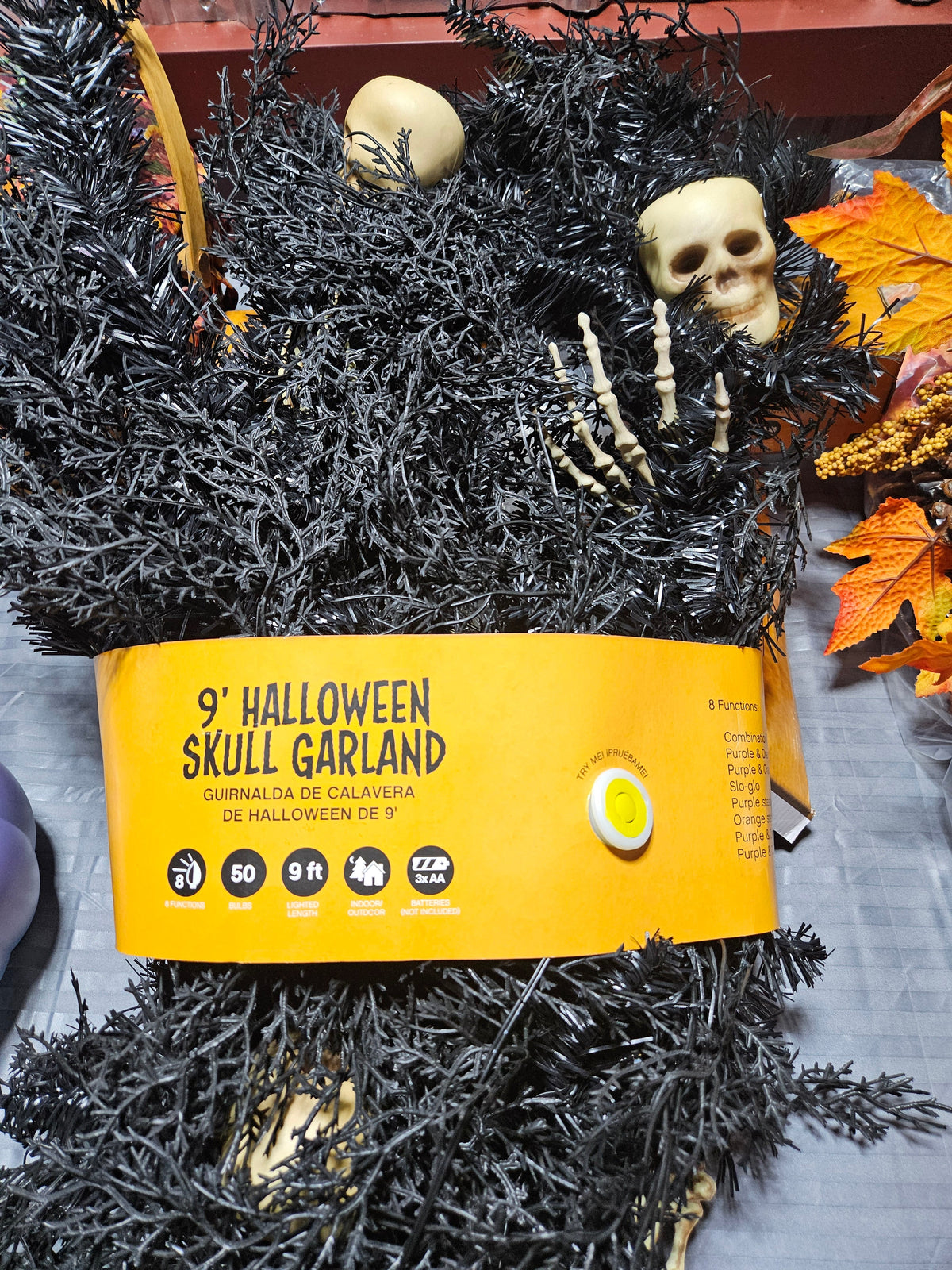 Celebrations 9 ft LED black skull Halloween garland with orange and purple lights, front product view
