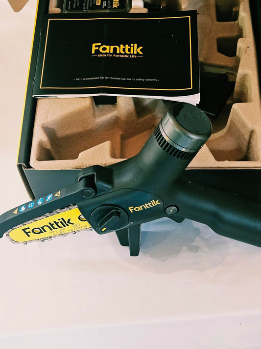 Fanttik W10 APEX chainsaw close up with manual and packaging insert