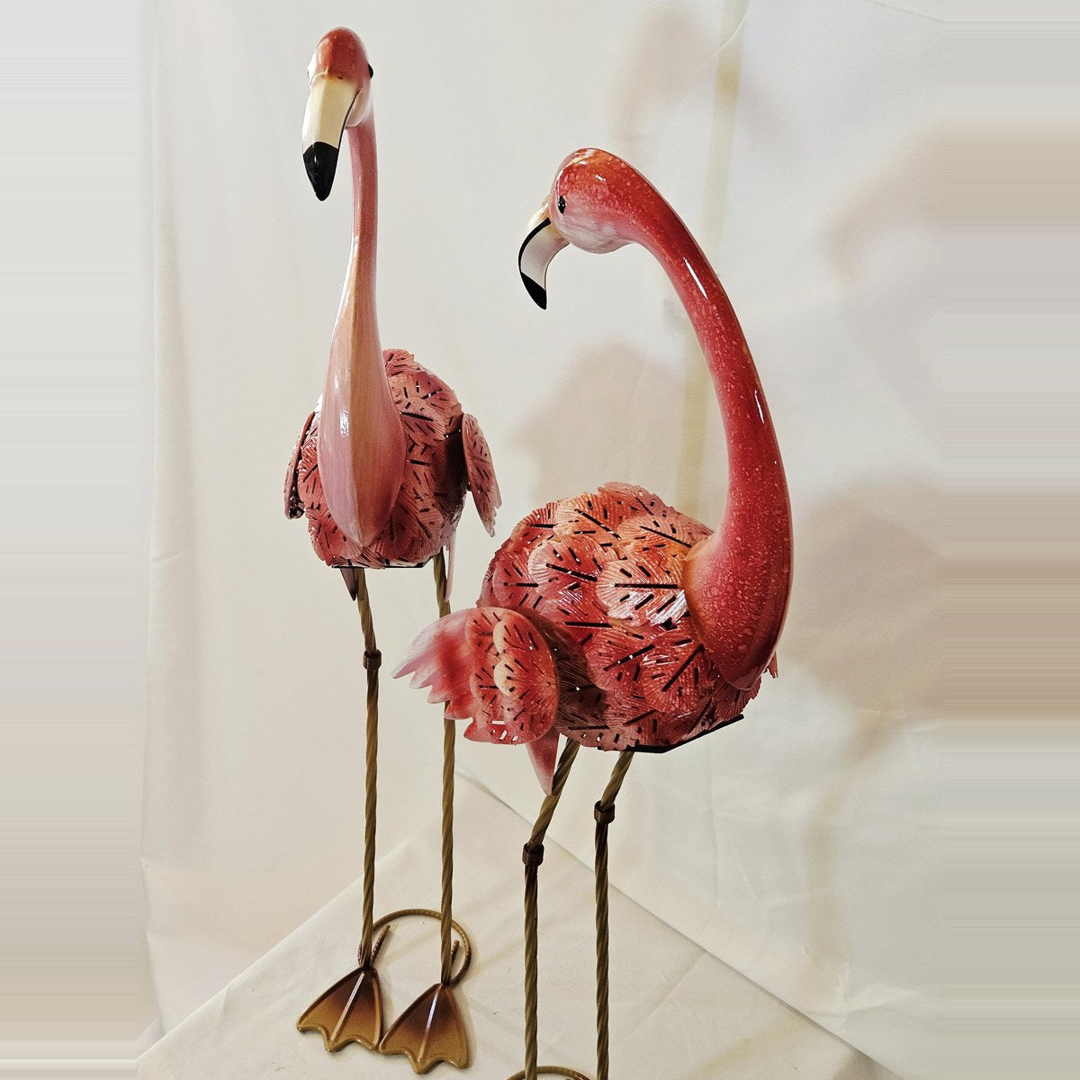 Metal flamingo statues front view