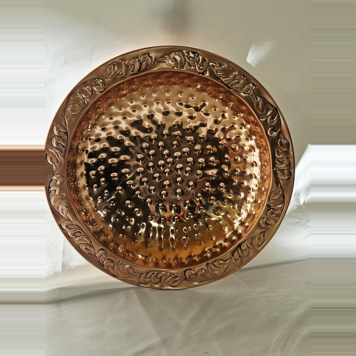 Hammered copper bird bath with embossed leaf rim