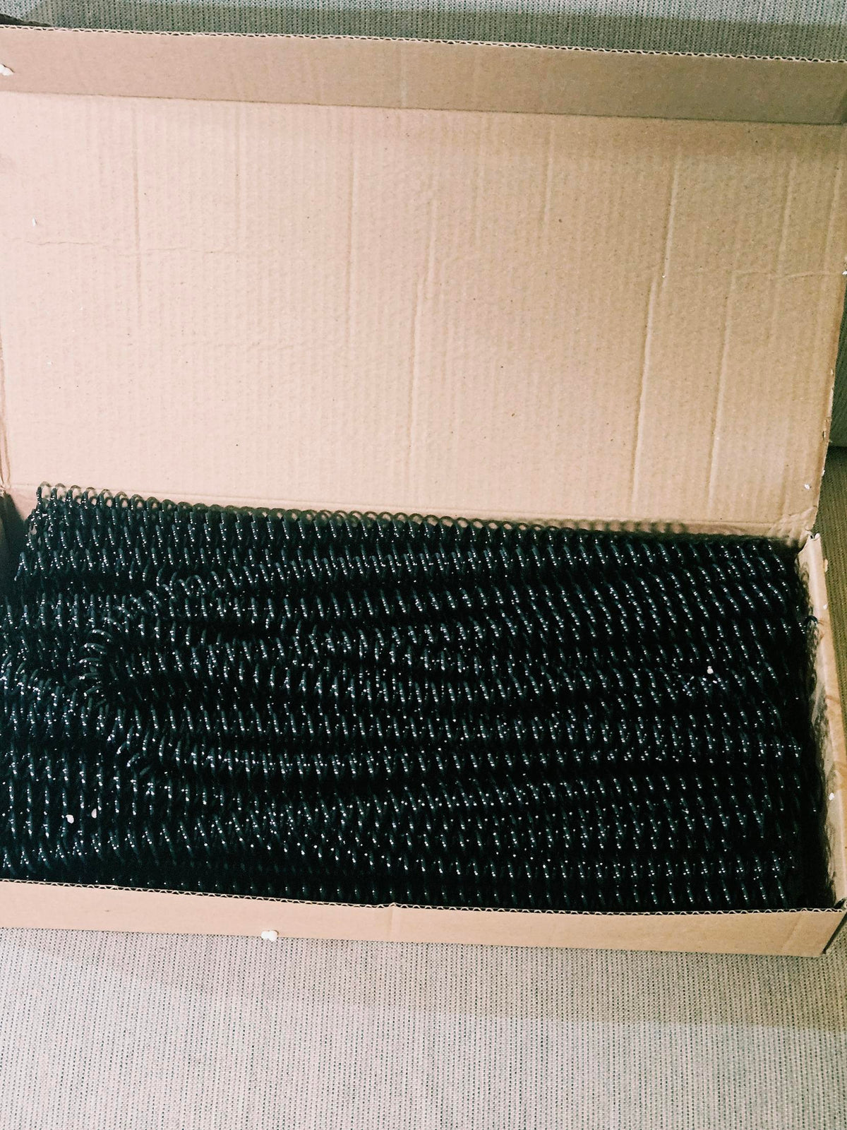 Included box of black plastic binding coils