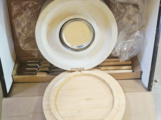 Open box showing stone fire bowl, gel fuel, bamboo lid and skewers all present